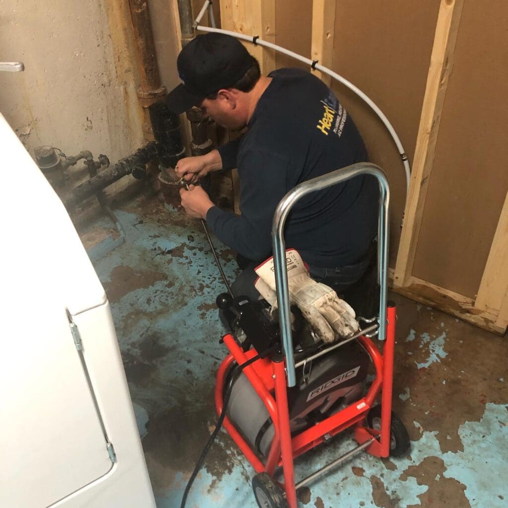 Jaxon the owner of Heartland Plumbing and heating Ltd, cleaning a drain and clearing a main drain in st albert emergency call