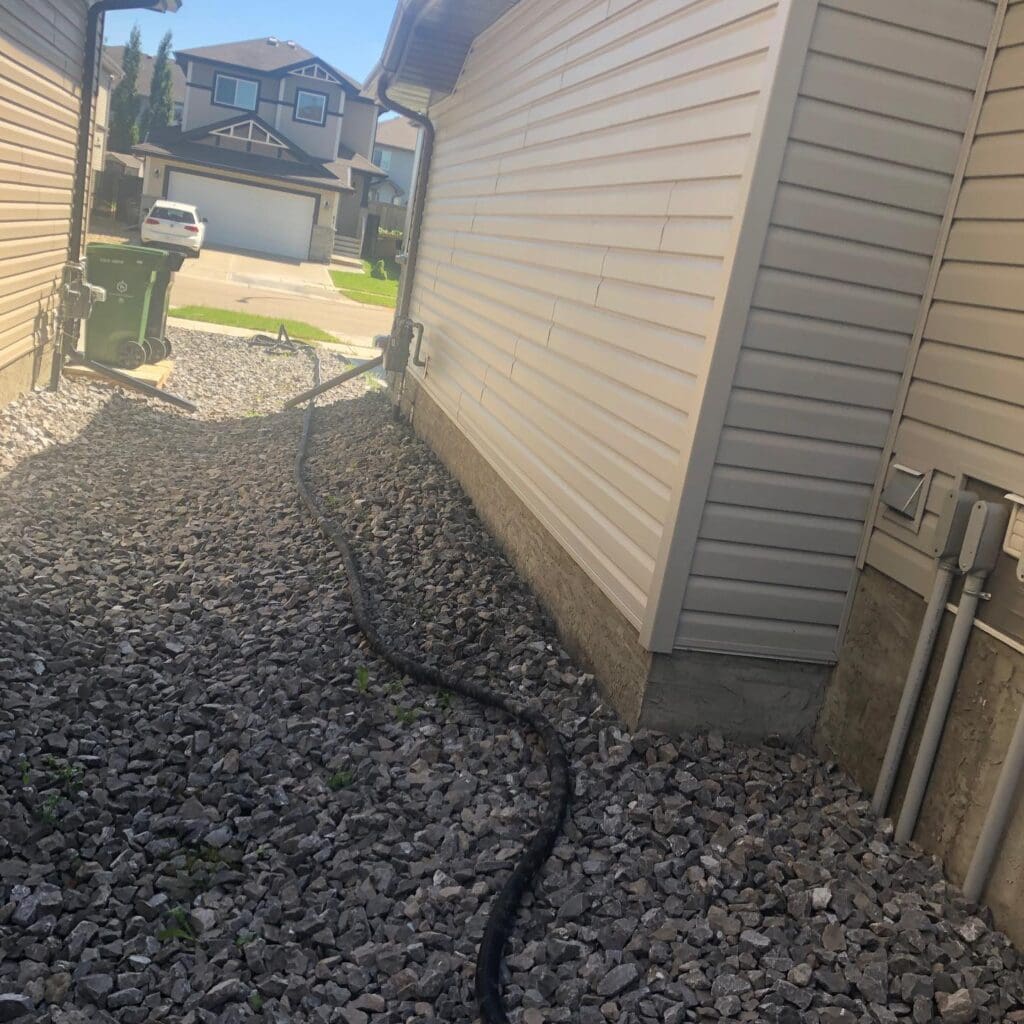 Piping a drain pipe of a sump punp into the floor drian of a santiary sewer in St Albert