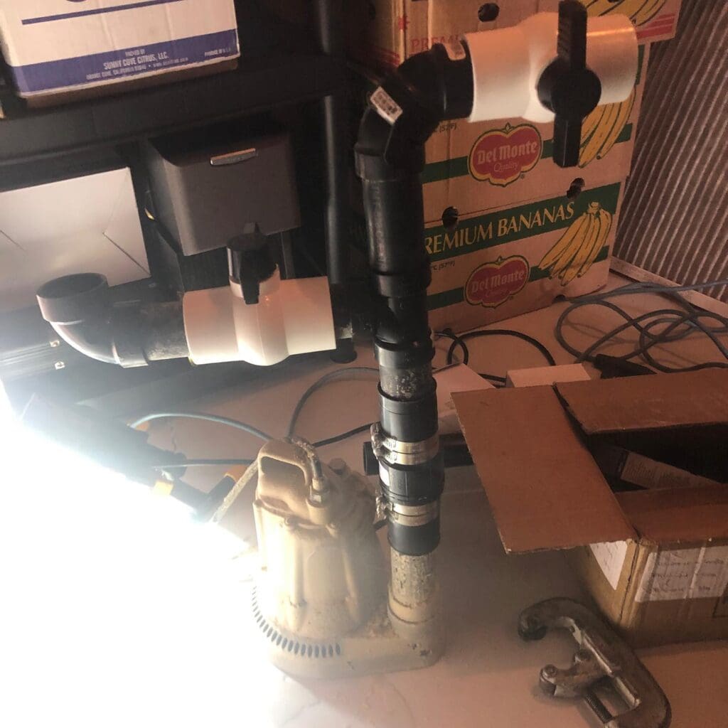 sump pump install in progress in fort sask plumbers from Heartland on emergency call