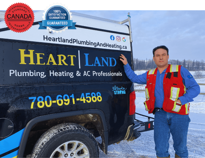 owner of heartland plumbing and heating ltd by his work truck, red seal badge and 100% satisfaction guarantee badge